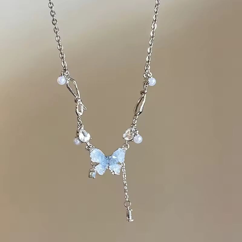 New arrival: Ice Crystal Gradient Pearl and Blue Zircon Butterfly Tassel Necklace. Elegance and grace, perfect as a gift.